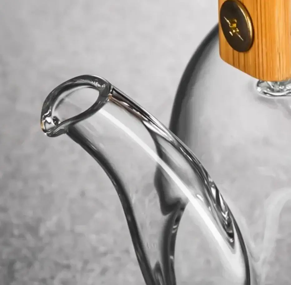 Clear glass tea pot with polished wooden handle and gold metal accent from decorbites glass tea collection