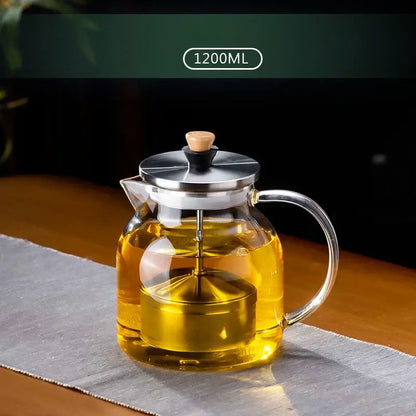 Decorbites glass tea set featuring clear glass teapot with stainless steel lid handle wooden knob and internal infuser