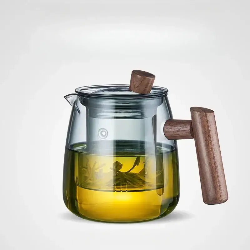 Decorbites™ glass tea set featuring clear glass teapot with wooden handle and internal infuser for steeping tea leaves