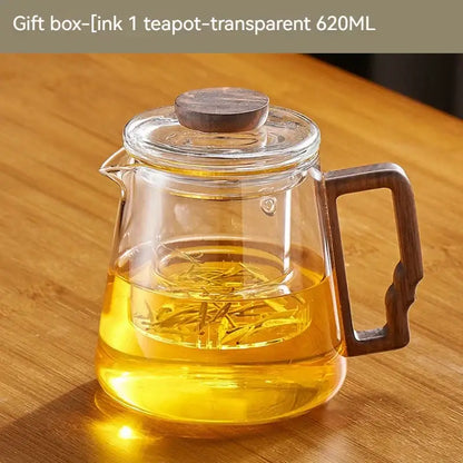 Decorbites glass teapot with dark wood lid and handle containing golden tea leaves steeping in amber liquid