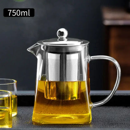 Clear glass teapot with stainless steel lid and built-in filter filled with golden tea from decorbites glass teapot kungfu tea set