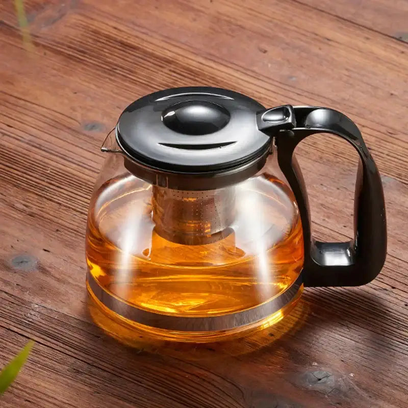 Clear glass teapot with black lid and handle featuring stainless steel infuser in decorbites glass teapot large capacity set