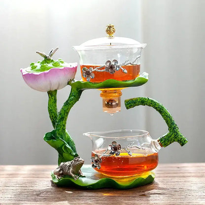 Decorbites glass teapot with lazy tea infuser featuring pink green lotus design and silver floral embellishments