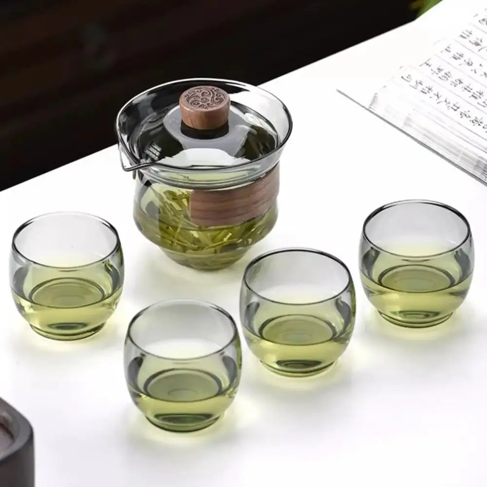 Clear glass teapot set with wooden lid and handle and four green-tinted cups decorbites glass teapot for kung fu tea