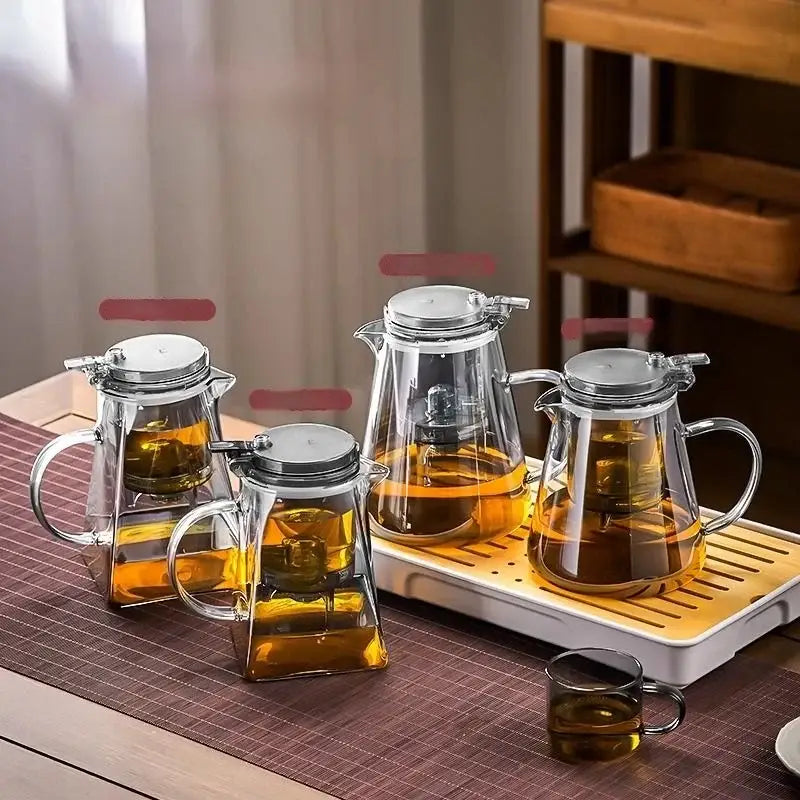 Clear glass tea infusers with silver lids handle filled with amber tea from decorbites glass teapot set heat-resistant filter