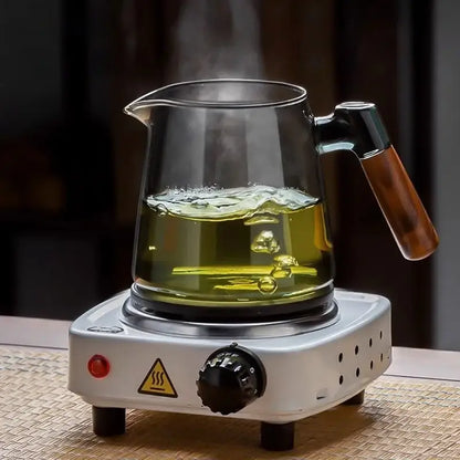 DecorBites glass teapot set with clear glass teapot and wooden handle steaming green tea on white electric base