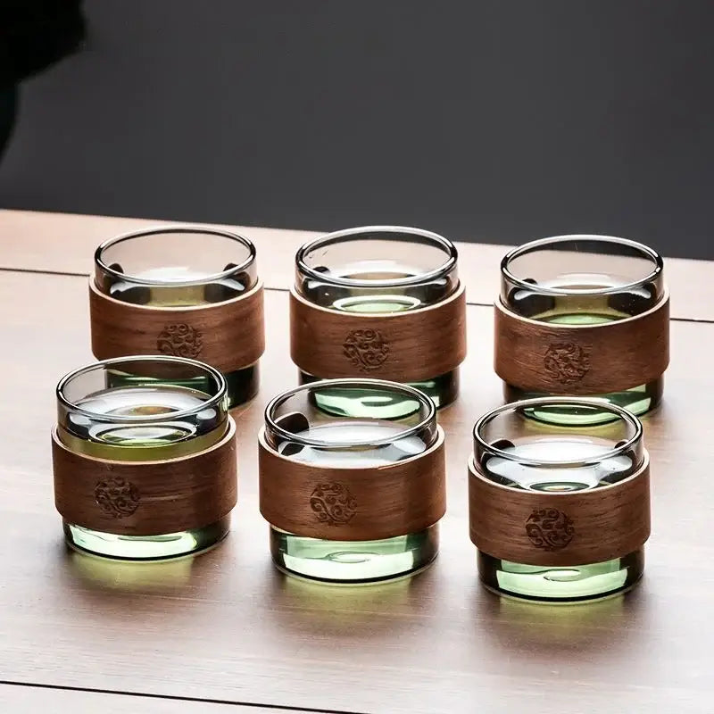 Decorbites glass teapot set with six clear glass teacups featuring amber wooden bands and engraved floral designs