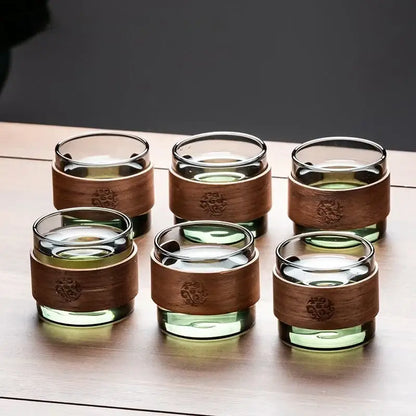 Decorbites glass teapot set with six clear glass teacups featuring amber wooden bands and engraved floral designs