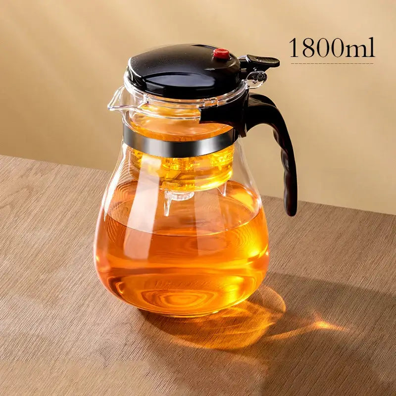 DecorBites glass teapot with black lid handle spout and silver band features one-button filter separation