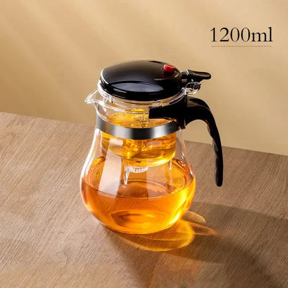 Clear glass decorbites glass teapot with black lid handle and silver metal band featuring one-button filter separation