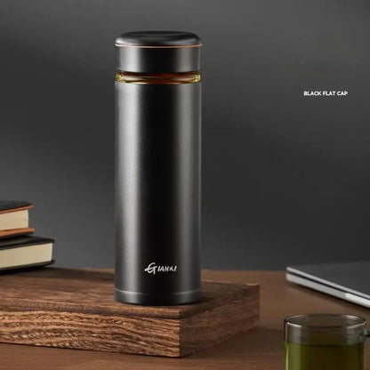 Black stainless steel thermos cup with tea separation feature and gold accent band featuring gianxi logo