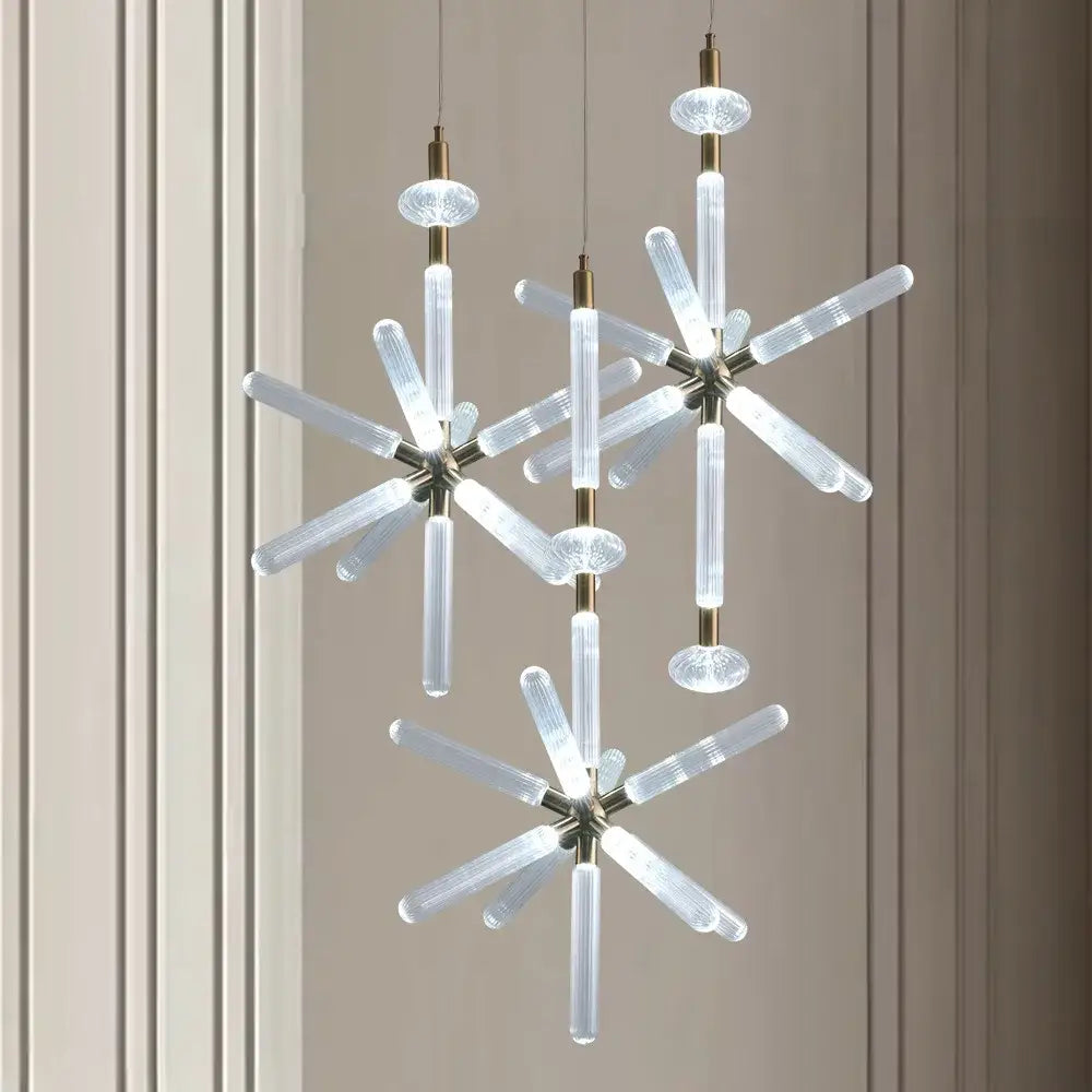 Modern starburst chandelier pendant lamp with clear ribbed glass tubes and brass accents by decorbites glass tubes