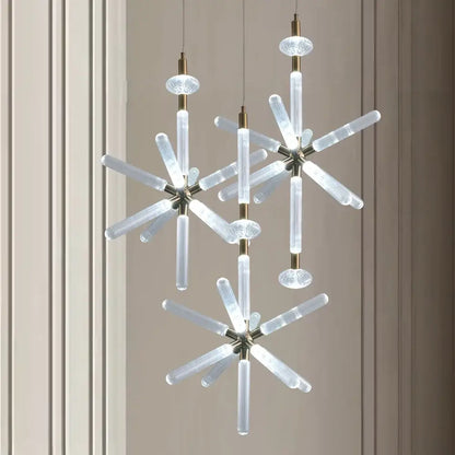 Modern starburst chandelier pendant lamp with clear ribbed glass tubes and brass accents by decorbites glass tubes