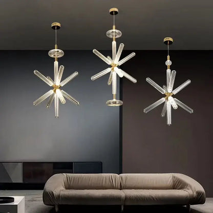 Three modern decorbites glass tubes led chandeliers with clear glass tubes and gold-toned metal fixtures