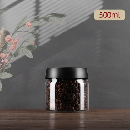 Clear glass jar with black lid filled with dark brown coffee beans from decorbites glass vacuum sealed canister
