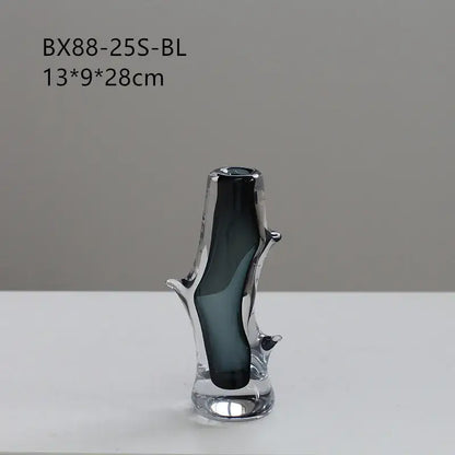A sleek dark gray decorbites glass vase with a transparent branch design and reflective base for floral arrangement
