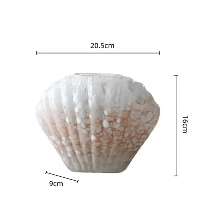 A delicate decorbites glass vase shell shaped with textured surface and embedded white and peach pebbles for home decor