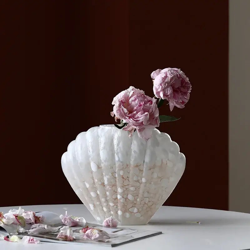 A translucent white DecorBites glass vase with a pebble texture holds delicate pink peonies for home decor