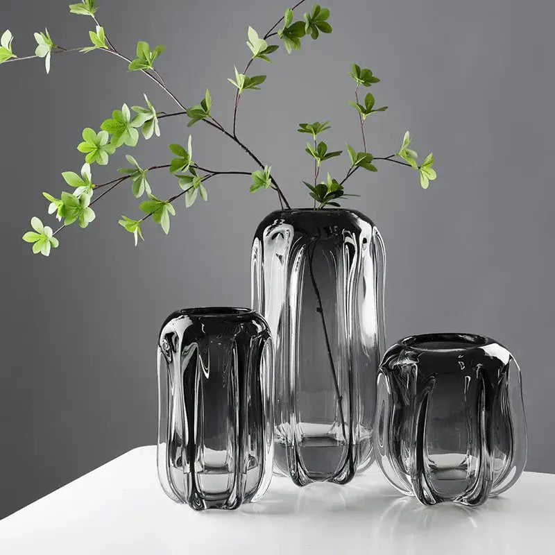 Set of three sleek translucent black decorbites glass vases with ridged texture for hydroponics and flower arrangement