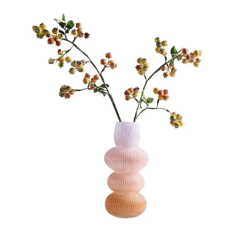 Pastel pink ribbed decorbites glass vase with stacked rounded tiers in geometric gradient design for home decoration