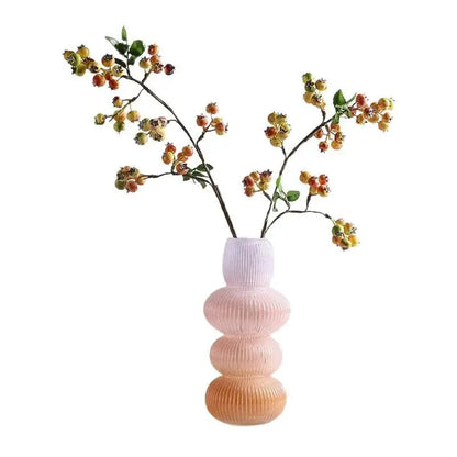 Pastel pink ribbed decorbites glass vase with stacked rounded tiers in geometric gradient design for home decoration