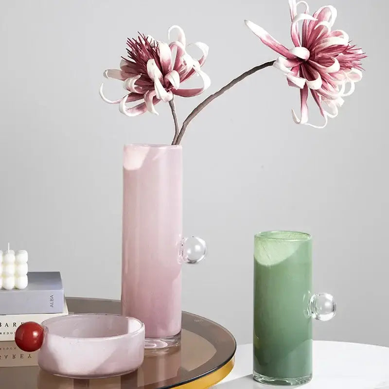 Pink frosted decorbites glass vase with geometric sphere clear handles and slender cylindrical shape for flowers and accessories