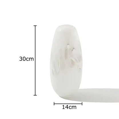 A translucent white decorbites glass vase with frosted floral etchings and a smooth rounded silhouette for elegant decor