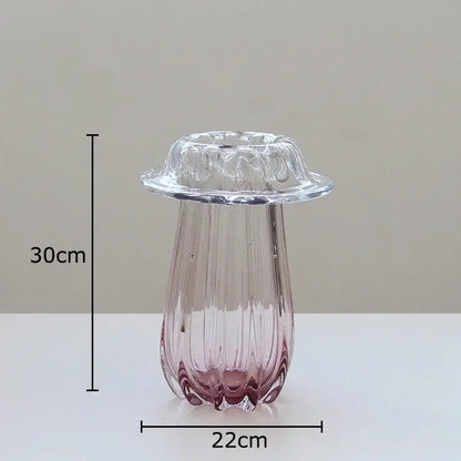A translucent pink decorbites glass vase with vertical ridges and scalloped rim for hydroponics table decor