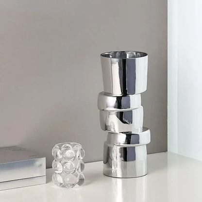 Stack of four sleek silver decorbites glass vases with twist shape for hydroponics and terrarium decoration accessories