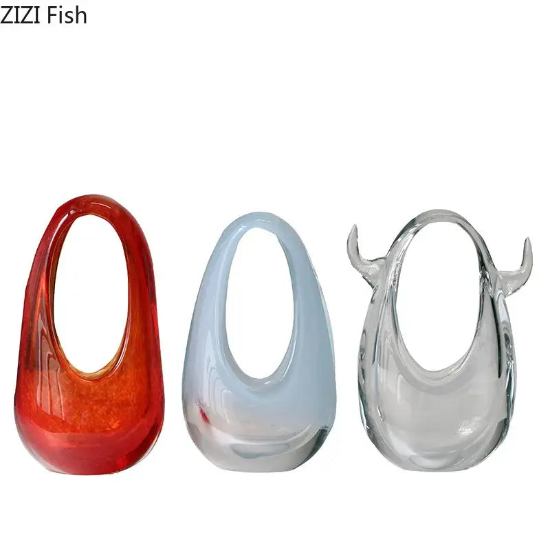Three translucent decorbites glass vases in red-orange light blue and clear with horn-like accents for terrarium use