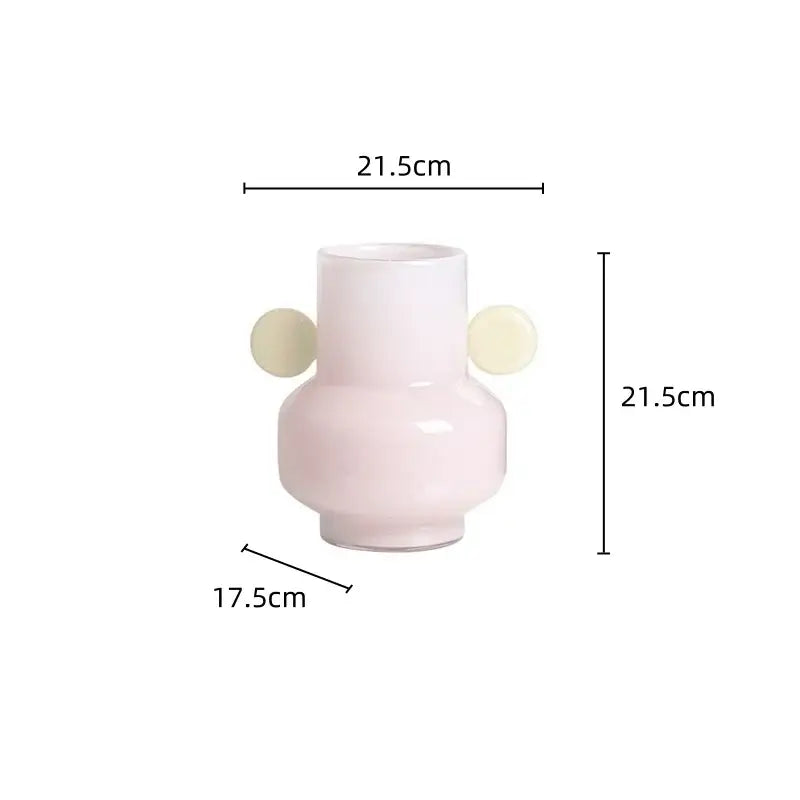 A sleek blush-pink ceramic decorbites glass vase with two cream spherical handles for floral arrangements