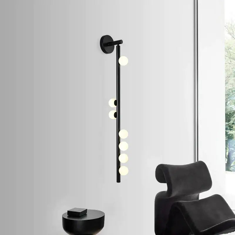 Black modern DecorBites glass wall lamp with slender stem and spherical bulbs for living room and bedroom use
