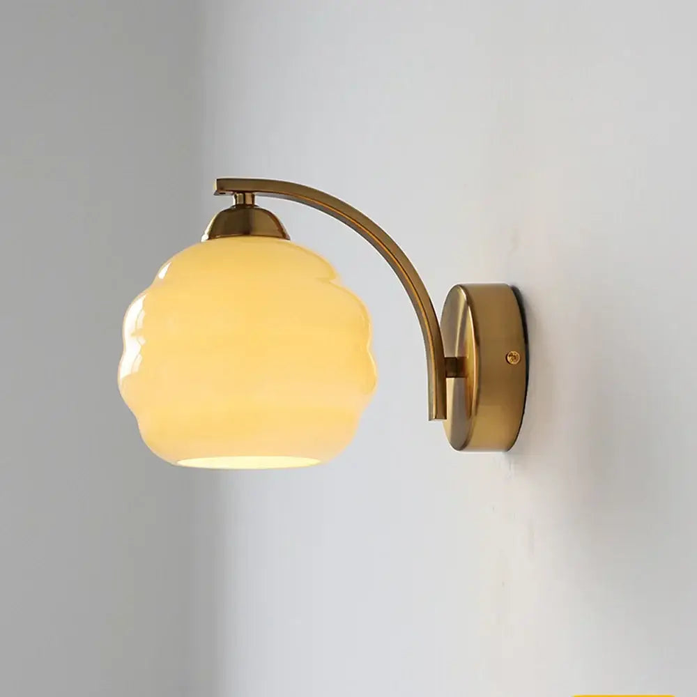 Decorbites glass wall lamp with warm-toned cloud-shaped glass shade and brass-finished metal arm for modern interiors