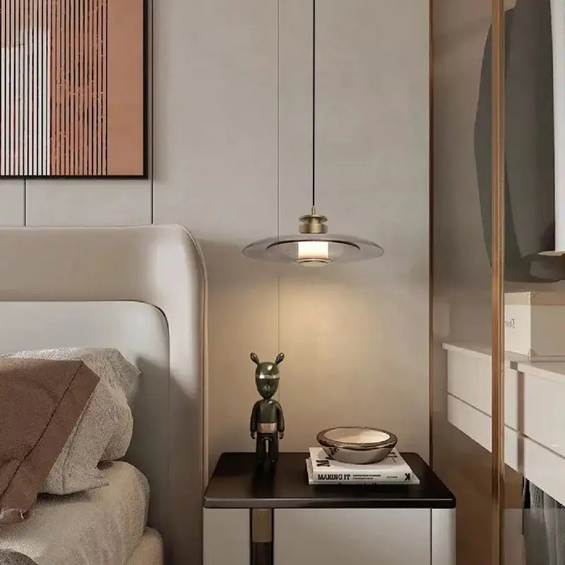 Modern minimalist decorbites glass wall lamp with circular brass shade and thin black cord for living and dining rooms
