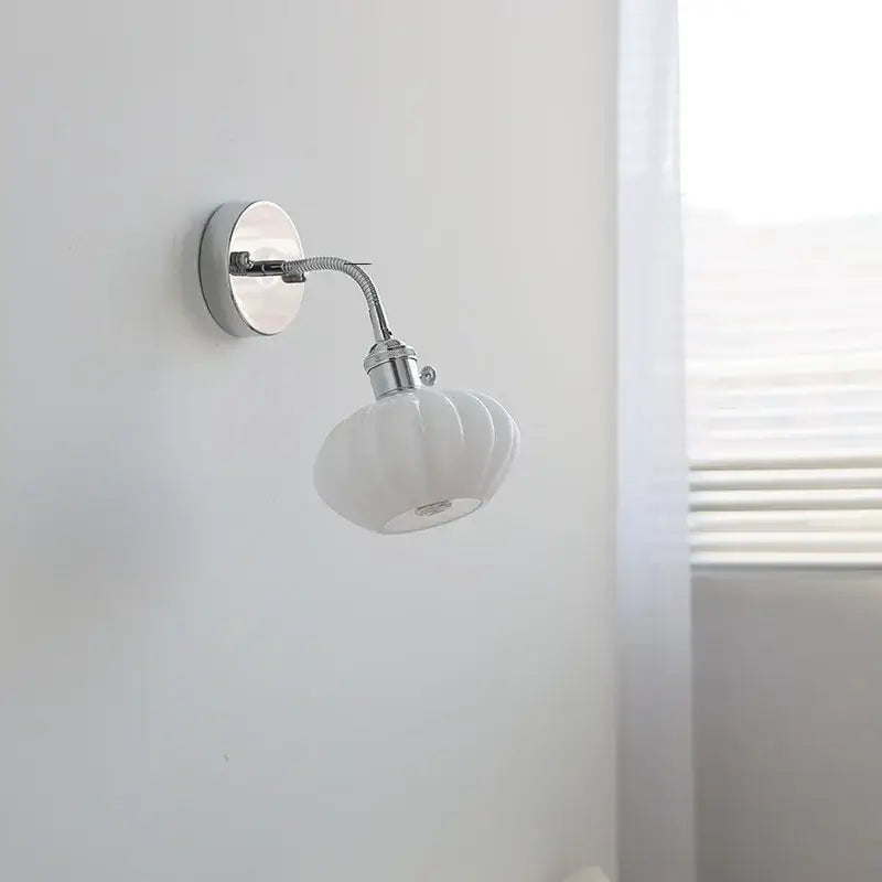 White ceramic wall light fixture with fluted shell-like shade and chrome metal arm by DecorBites™ with pull chain switch