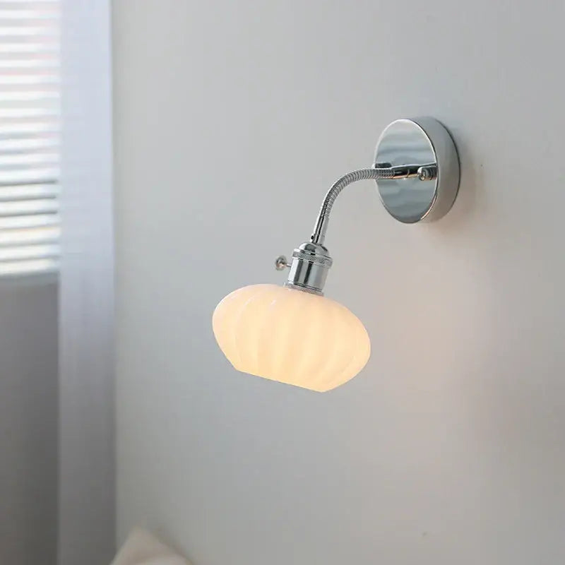 DecorBites™ glass wall light fixture with chrome finish, adjustable arm, pull chain switch, and off-white glass shade