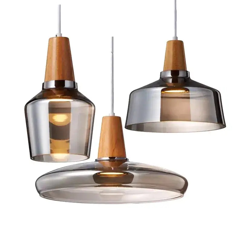 Three modern DecorBites glass pendant lights with smoked glass and warm wood accents for dining and bar areas