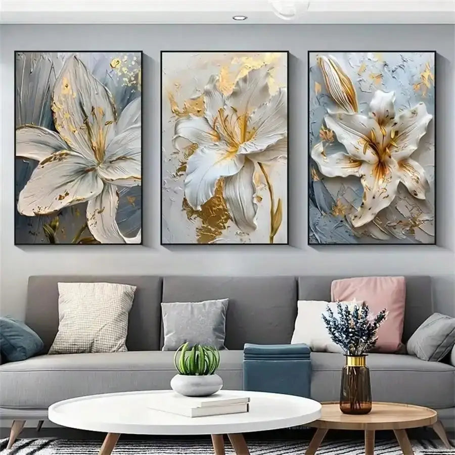 DecorBites Gold and White floral 3D canvas wall art featuring three white flower canvas posters with gold accents above sofa