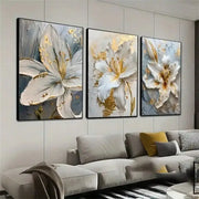 Decorbites gold and white floral 3d canvas wall art featuring three-panel white flower canvas with gold accents and textured brushstrokes framed in black
