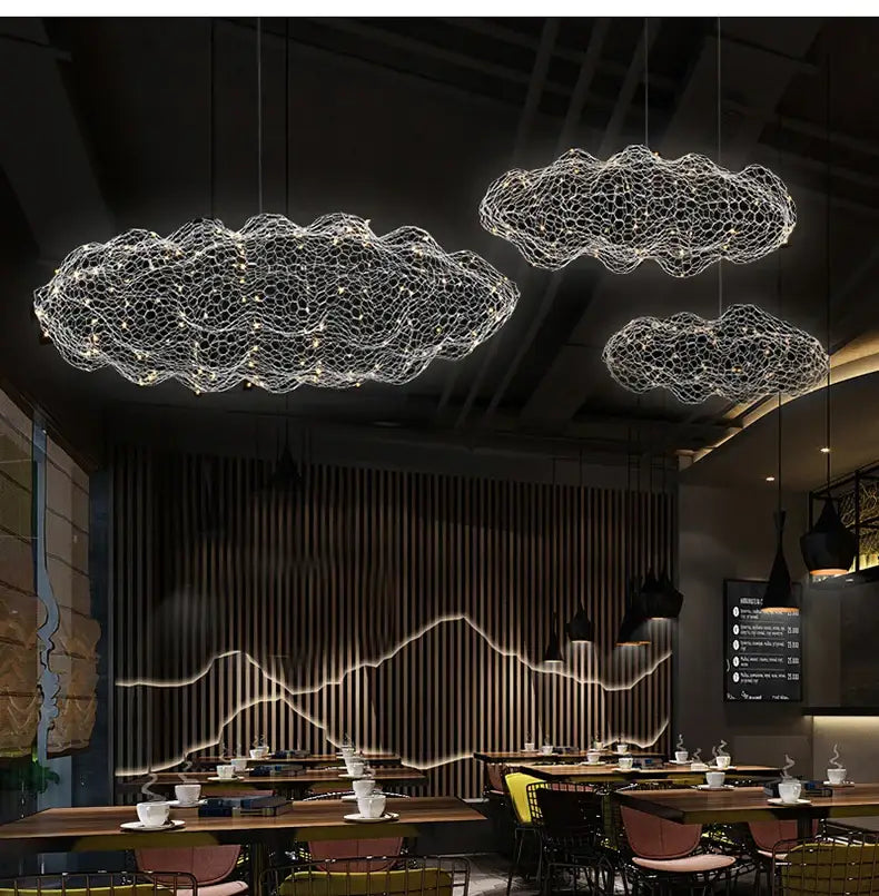 Three gold metallic wireframe cloud pendant lights illuminate ceiling perfect for home and restaurant decor