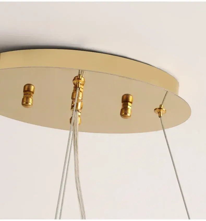 Gold-toned circular ceiling mount with polished metal hardware and clear cables for decorbites gold crystal led chandelier