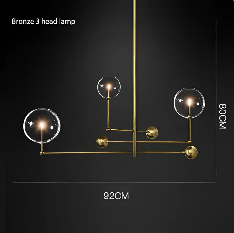 Bronze 3-head lamp with polished brass arms and gold glass bubble spherical globes for dining room decor
