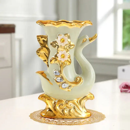Decorbites gold glass vase shaped like a swan with gold accents and white floral embellishments for stylish decor