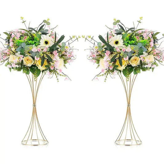 Elegant gold-toned iron flower vases with wireframe pedestal stands holding artificial soft pink yellow and white flowers