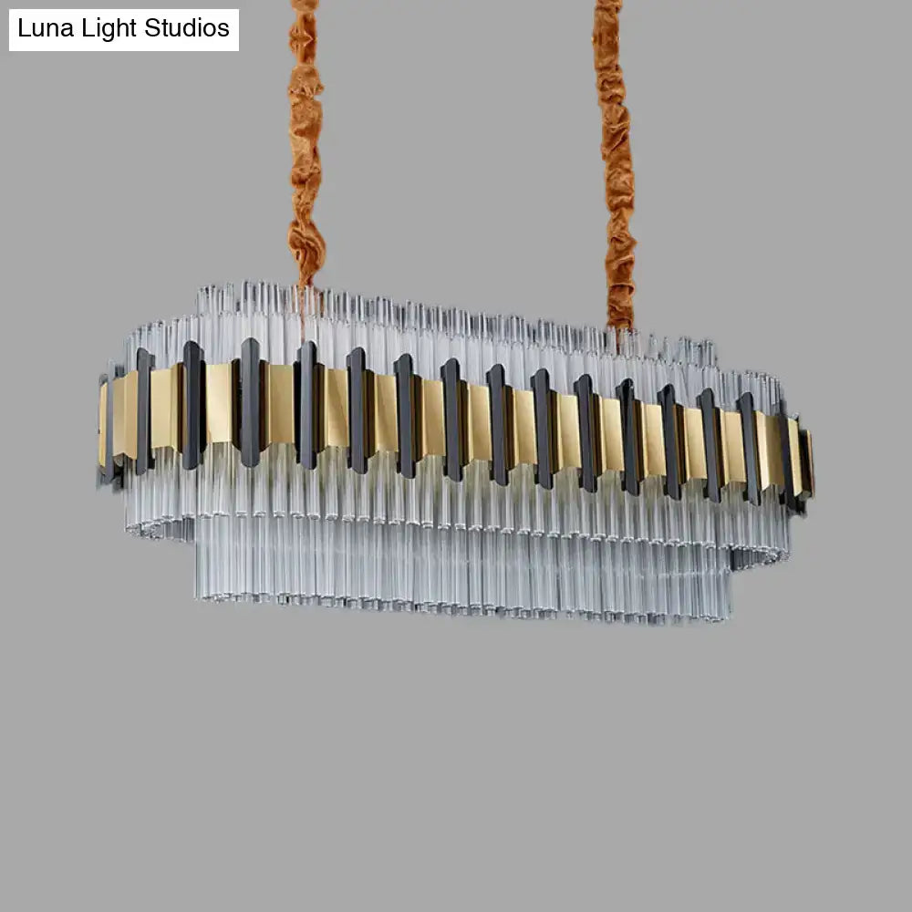 Decorbites gold led island chandelier with oval clear glass tubes and gold black metal accents suspended by brown cords