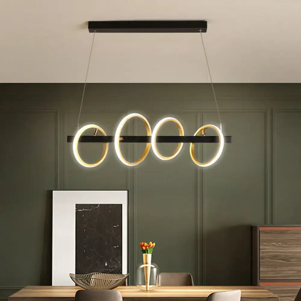 Modern black and gold metal ceiling pendant with simple circles design and warm light for dining room island illumination
