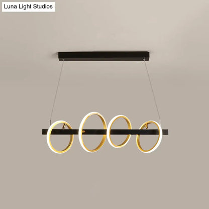 Modern black and gold metal ceiling pendant with simple circles design and illuminated rings for dining room island lighting
