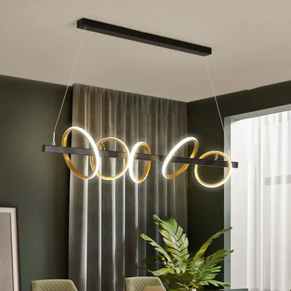 Modern black and gold metal ceiling pendant with simple circles design and glowing LEDs for dining room island lighting