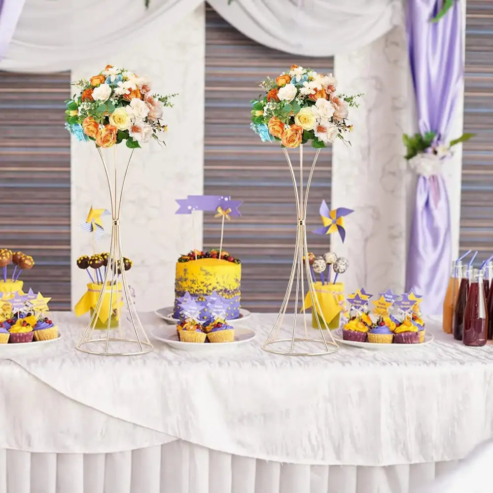 DecorBites gold metal trumpet flower stands with vibrant orange white and blue floral arrangements in metal trumpet vases