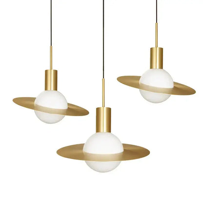 Three decorbites gold modern pendant lights with glass filament bulbs and gold metal fixtures for dining room use